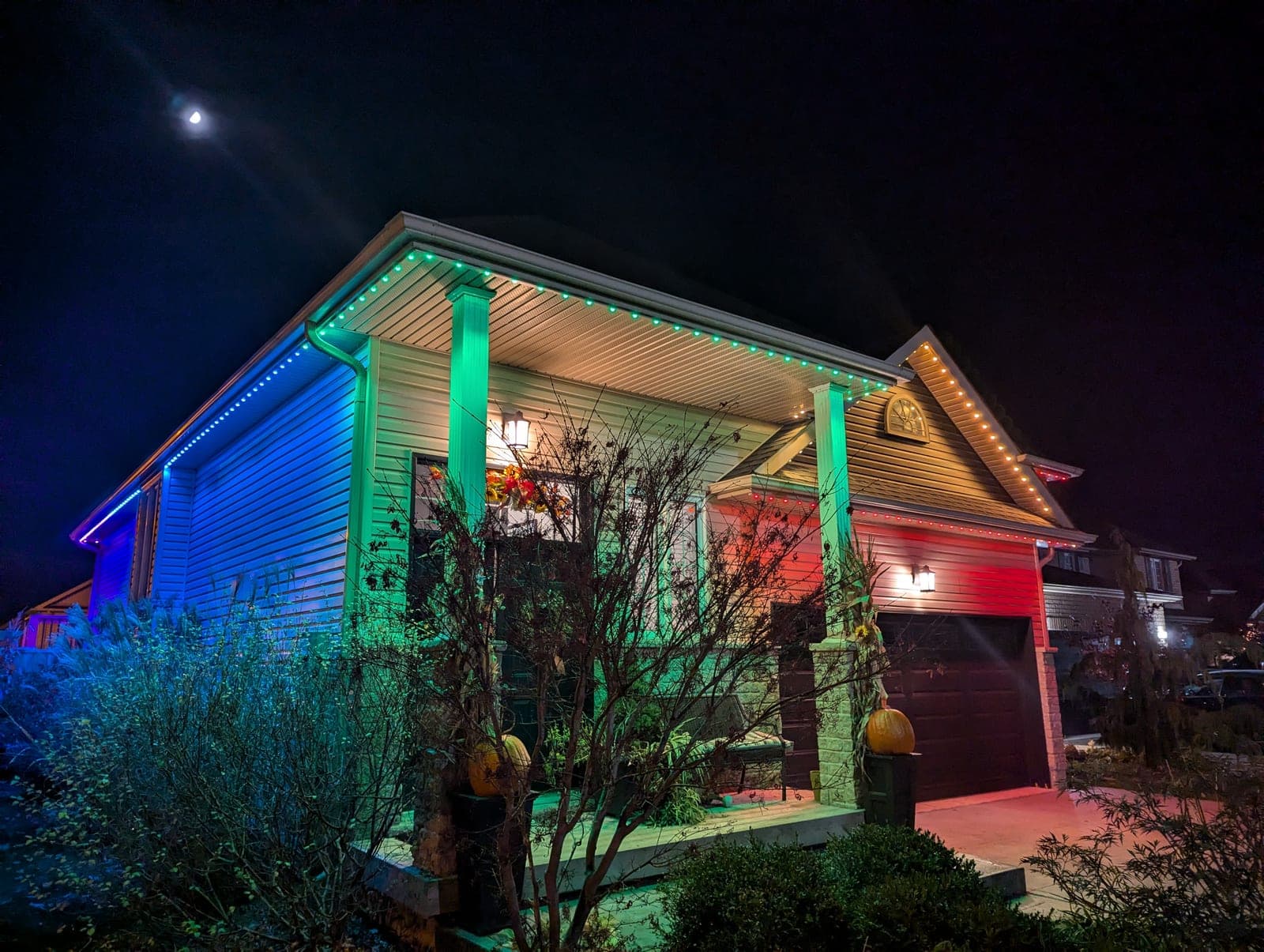 Split image comparing a warm white C9 seasonal roofline display and a discreet permanent RGBW channel light on similar Southern Ontario homes